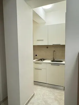 a kitchen with white cabinets and a sink at Casa Ponticello in Termini Imerese