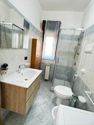 a bathroom with a sink and a toilet and a shower at Casa Ponticello in Termini Imerese