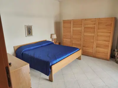 a bedroom with a blue bed in a room at Villa Tecla in Altofonte