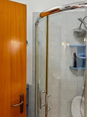 a bathroom with a blue toilet and a sink at Villa Tecla in Altofonte