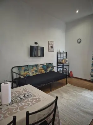 a living room with a couch and a table at La Casuzza 2 in piazzetta in Palermo