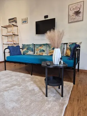 a blue couch in a living room with a table at La Casuzza 2 in piazzetta in Palermo