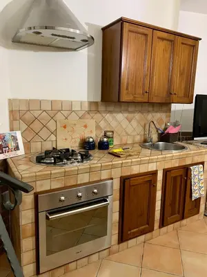 a kitchen with a stove and a sink at Vucciria Holiday - Centro storico - via Emanuele in Palermo