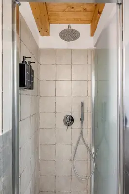 a bathroom with a shower with a glass shower at Appartamento Amari 148 in Palermo