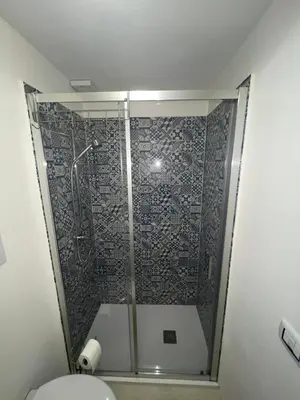 a bathroom with a shower with a toilet in it at La Maiolica 61 in Terrasini