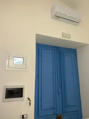 a blue door in a room with a ceiling at La Maiolica 61 in Terrasini