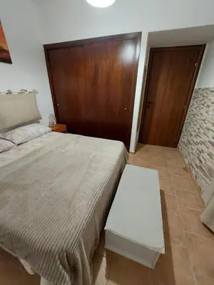 a bedroom with a bed and a wooden door at Il Rifugio Delle Giuiuzze in Palermo
