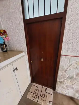 a wooden door in a room with a stone wall at Il Rifugio Delle Giuiuzze in Palermo