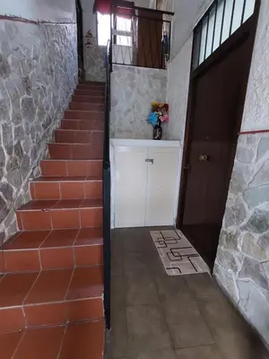 a stairway with a white door and a staircase with a stone wall at Il Rifugio Delle Giuiuzze in Palermo