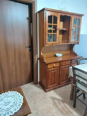 a room with a wooden cabinet and a table at Il Rifugio Delle Giuiuzze in Palermo