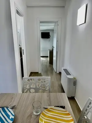 a kitchen and dining room with a table and chairs at Terrasini Center Apartments in Terrasini