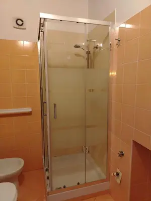 a glass shower in a bathroom with a toilet at Vittorio Cathedral House in Palermo