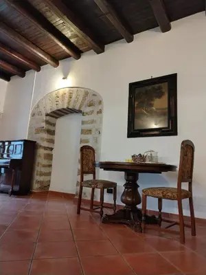 a dining room with a table and two chairs at Vittorio Cathedral House in Palermo