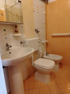 a bathroom with a toilet and a sink at Vittorio Cathedral House in Palermo