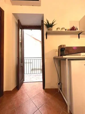 a kitchen with a door leading to a balcony at Casamori 1-centro storico Palermo in Palermo