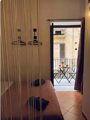 a room with a bed and a door to a patio at Casamori 1-centro storico Palermo in Palermo