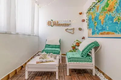 a room with two chairs and a table and a world map at GuestHost - La Rosa di Ballarò Palermo Apartment in Palermo