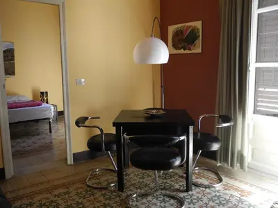 a dining room with a table and four chairs at Kalsa Apartment in Palermo