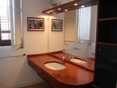 a bathroom with two sinks and a large mirror at Kalsa Apartment in Palermo
