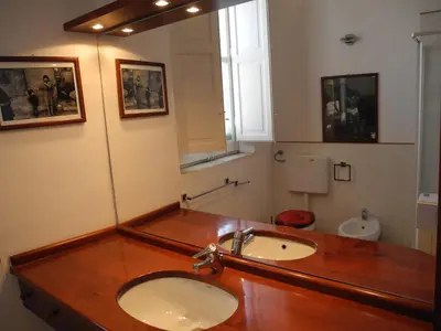a bathroom with a sink and a toilet at Kalsa Apartment in Palermo