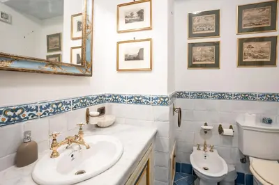 a bathroom with a sink and a toilet at Principe di Castelnuovo Historical Suites in Palermo