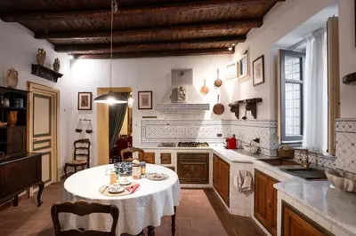 a kitchen with a table with a white table cloth at Principe di Castelnuovo Historical Suites in Palermo