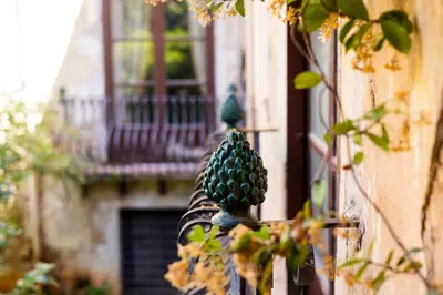 a green pineapple on the side of a building at Principe di Castelnuovo Historical Suites in Palermo