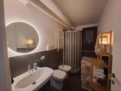 a bathroom with a sink toilet and a mirror at La Lunetta - romantic little house in Palermo