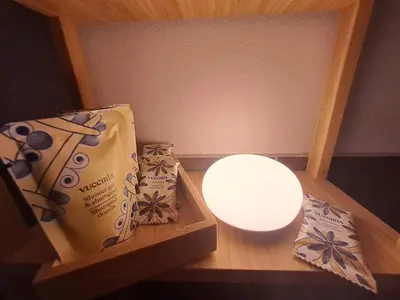 a room with two boxes and a light on a table at La Lunetta - romantic little house in Palermo