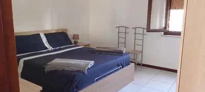 a bedroom with a blue bed with two pillows on it at Molo Sbrijù - Palermo Centro in Palermo