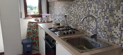 a kitchen with a sink and a stove at Molo Sbrijù - Palermo Centro in Palermo