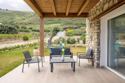 a patio with chairs and a table with a view at Villa Manù country house in Castellammare del Golfo