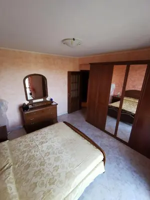 a bedroom with a bed and a mirror and a tv at Località Cefalù - Villa indipendente con giardino in Lascari