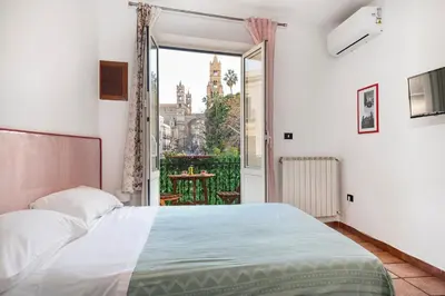a bedroom with a bed and a large window at Cathedral View Apartment 2 Stanze Matrimoniali con Balcone in Centro in Palermo