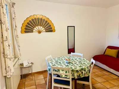 a dining room with a table and a bed at Cathedral View Apartment 2 Stanze Matrimoniali con Balcone in Centro in Palermo