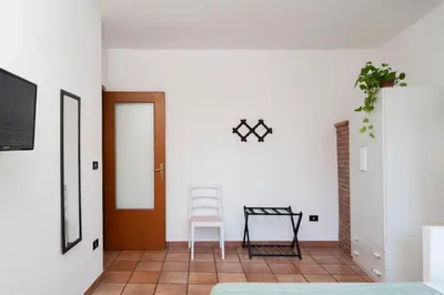 a room with a door and a chair and a table at Cathedral View Apartment 2 Stanze Matrimoniali con Balcone in Centro in Palermo