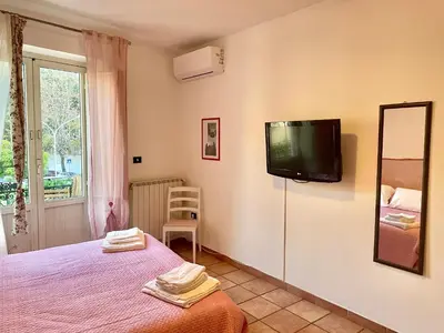 a bedroom with a bed and a tv on the wall at Cathedral View Apartment 2 Stanze Matrimoniali con Balcone in Centro in Palermo