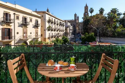 a table with food and drinks on a balcony at Cathedral View Apartment 2 Stanze Matrimoniali con Balcone in Centro in Palermo
