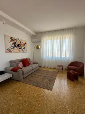 a living room with a couch and a chair at Clar Suite -Grattacielo in Palermo
