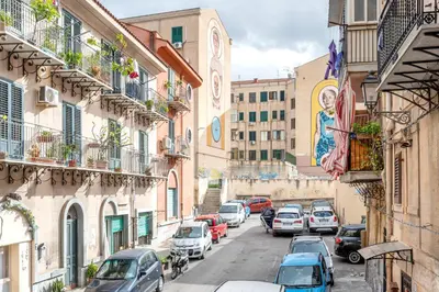 a city street with cars parked on the street at Alabardieri Apartments by Wonderful Italy in Palermo