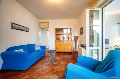 a bedroom with a bed with a colorful comforter and two lamps at Sirene Blu Mondello in Palermo