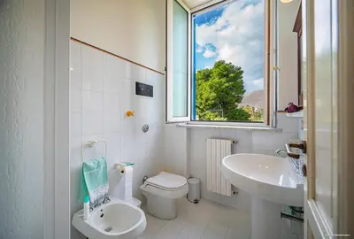 a bathroom with a sink and a window at Sirene Blu Mondello in Palermo