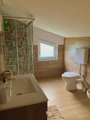 a bathroom with a tub and a toilet and a sink at Villa Falco in Carini