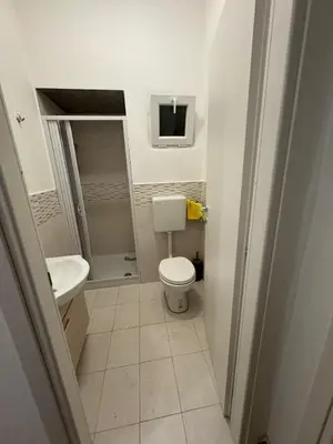 a small bathroom with a toilet and a sink at St Joseph in Terrasini