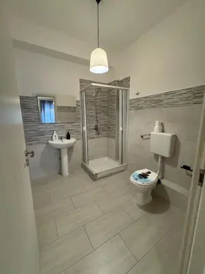 a bathroom with a toilet and a shower and a sink at St Joseph in Terrasini