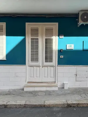 a blue and white building with a door and window at St Joseph in Terrasini