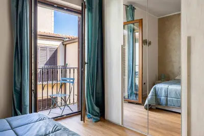 a bedroom with a view of a bed and a balcony at Baglio dei Conti d'Orléans in Palermo
