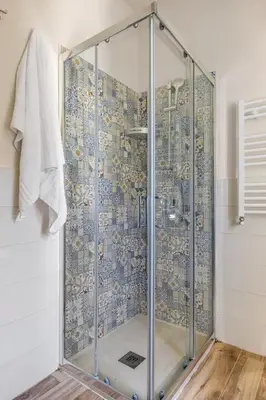 a shower with a glass door in a bathroom at Baglio dei Conti d'Orléans in Palermo