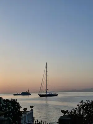 a sailboat in the water with two ships in the distance at Finestra sul Golfo in Mondello