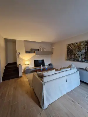 a living room with a couch and a television at Finestra sul Golfo in Mondello